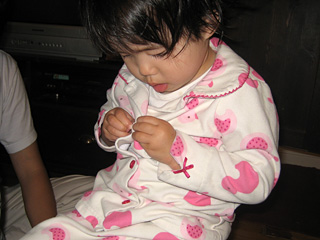 miranda buttoning her pajamas
