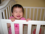 Eleanor Smiling in Her Crib