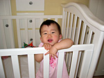 Miranda Smiling in Her Crib