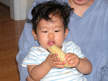 Holding a piece of corn